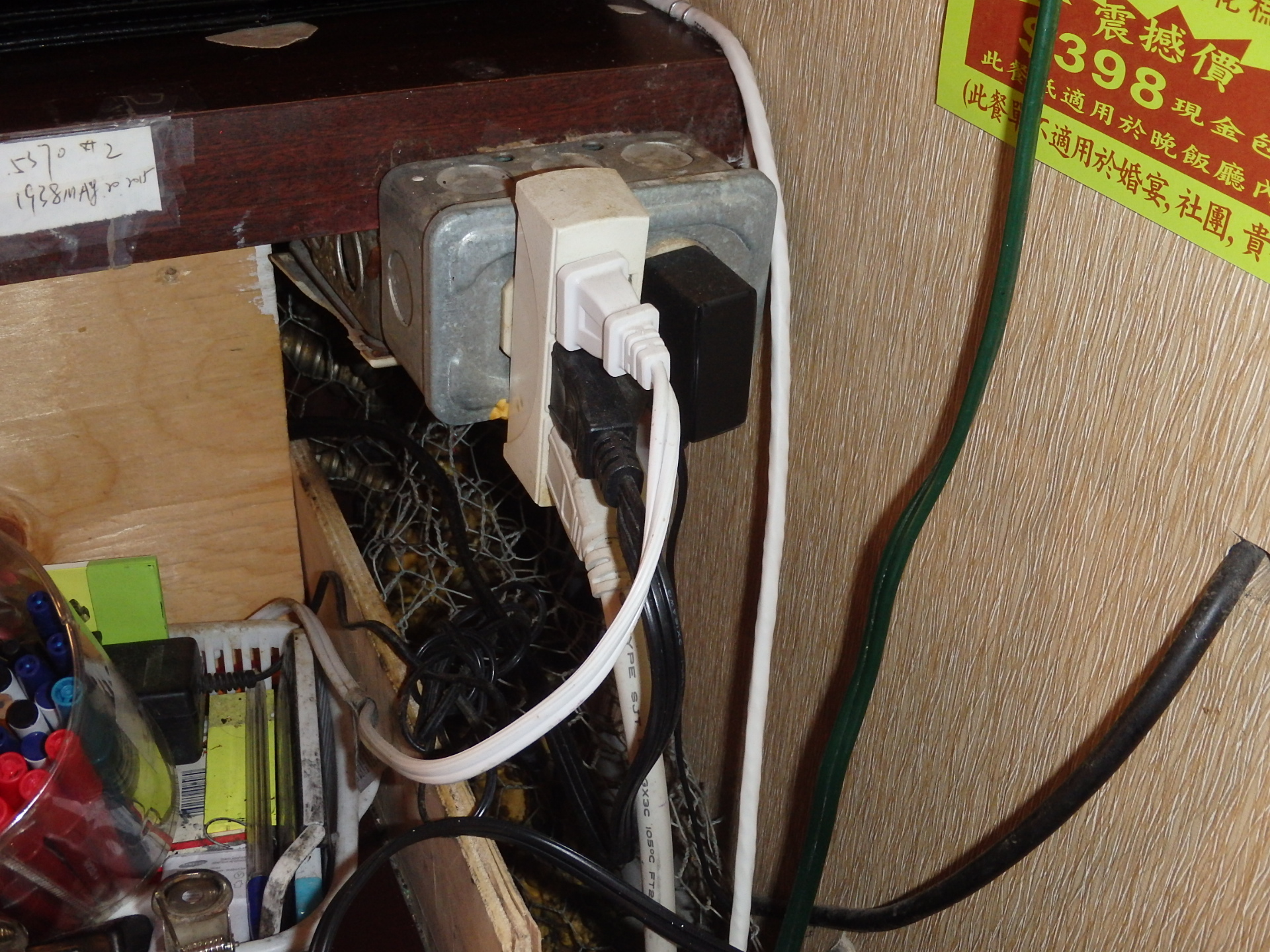 This image shows a hazardous electrical setup with multiple overloaded power outlets, which pose a significant fire and safety risk. Identified Hazards & Concerns:
⚠ Overloaded Power Strip & Adapters – Too many devices are plugged into a single power source, increasing the risk of overheating and electrical fires.
⚠ Use of Multi-Plug Adapters – Stacking multiple plug adapters can overload circuits and cause loose connections, leading to sparks or fires.
⚠ Exposed & Tangled Wires – Poor cable management can lead to damage, short circuits, and tripping hazards.
⚠ Improper Electrical Box Installation – The metal electrical box appears to be in a high-risk area, possibly making it vulnerable to physical damage.
⚠ Flammable Surroundings – The area contains wooden materials and paper, which could easily catch fire if an electrical fault occurs. Recommended Actions:
✅ Reduce Load on the Outlet – Use dedicated circuits for high-power devices instead of overloading a single outlet.
✅ Replace Multi-Plug Adapters with a Surge-Protected Power Strip – A UL-listed surge protector with an appropriate amp rating is much safer.
✅ Improve Wire Management – Organize and secure cables to prevent overheating and damage.
✅ Inspect for Electrical Code Violations – A licensed electrician should evaluate this setup to ensure compliance with safety regulations.
✅ Keep Flammable Items Away – Remove any paper, wooden materials, or other combustible objects near electrical outlets.