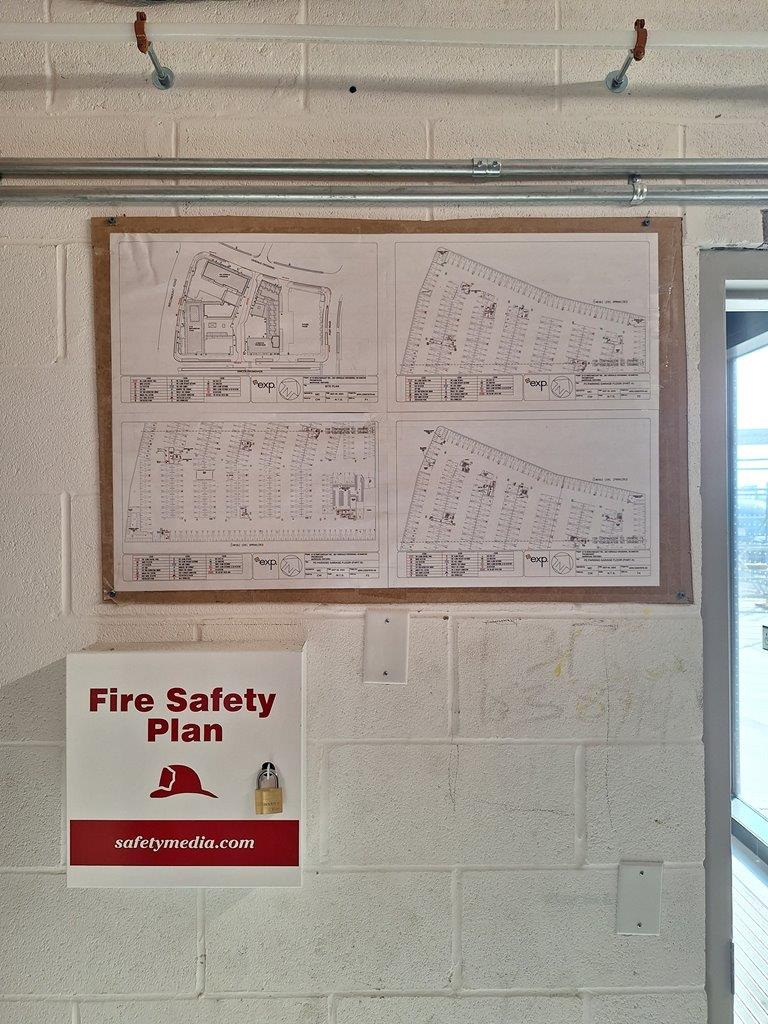 This image shows a Fire Safety Plan station, which includes: A Fire Safety Plan Box The box is labeled "Fire Safety Plan" and features a padlock, indicating that the plan is secured but accessible to authorized personnel.
This is essential for emergency responders who may need quick access to the fire safety documents, evacuation procedures, and building systems information during an incident.
Building Fire Safety Drawings The site and floor plans displayed above the box appear to contain fire protection details, exit routes, and emergency equipment locations.
These are passive fire protection graphics, providing vital information for occupants and emergency personnel.
Recommendations for Fire Safety Compliance
✔ Ensure the Fire Safety Plan box is accessible and that keys are available to fire department personnel.
✔ Confirm that fire plans are up-to-date and comply with local fire codes (e.g., NFPA 101, local fire department requirements).
✔ Regularly inspect and update the posted graphics to ensure accuracy in case of modifications to the building layout.
✔ Consider adding emergency contact numbers and fire alarm instructions near the display for quick reference.
This setup supports code compliance and life safety measures, helping first responders and building occupants in the event of an emergency